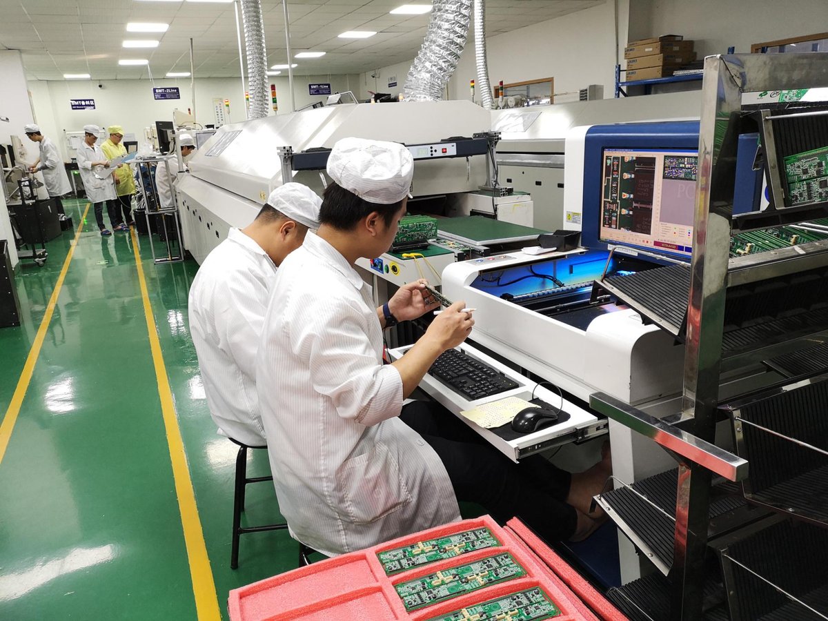 SMT line operator inspecting boards